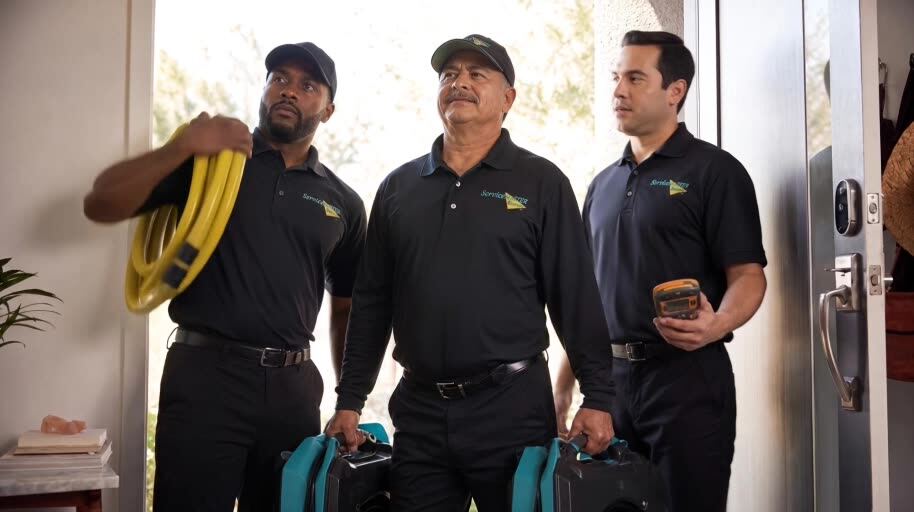 Approved generated ServiceMaster shot: crew standing in the doorway